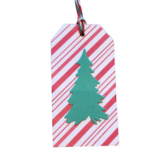 Handmade Christmas gift tag with red-and-white diagonal candy cane stripes, dimensional green Christmas tree, and red, green, and white cord.