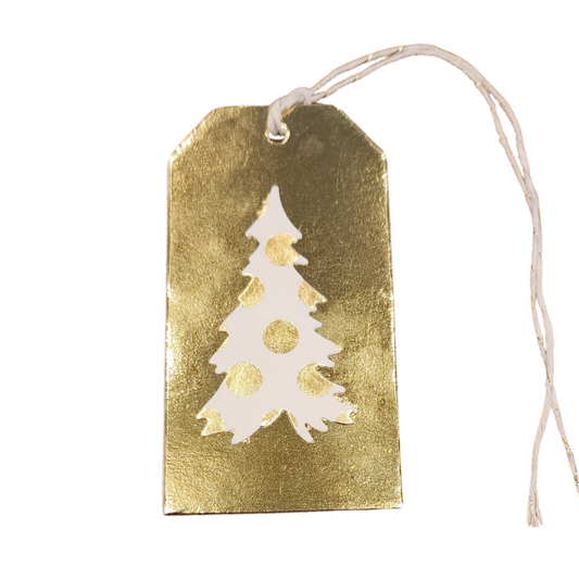 Handmade gold foil Christmas gift tag featuring a white Christmas tree with gold polka dots and a white and gold hanging cord.
